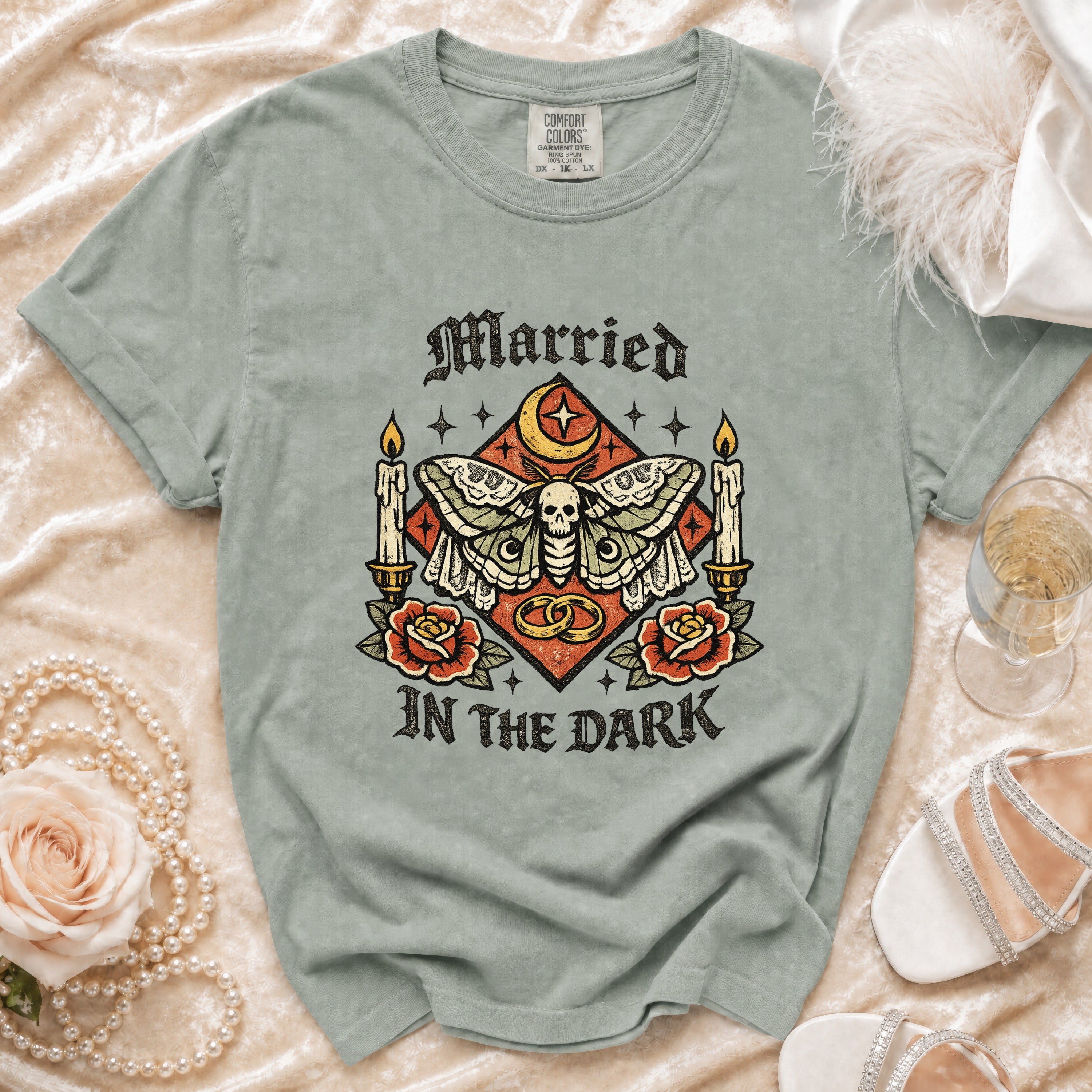 Green t-shirt with "Married In The Dark" text and moth graphic.