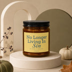 Amber jar candle with black lid labeled "No Longer Living In Sin".
