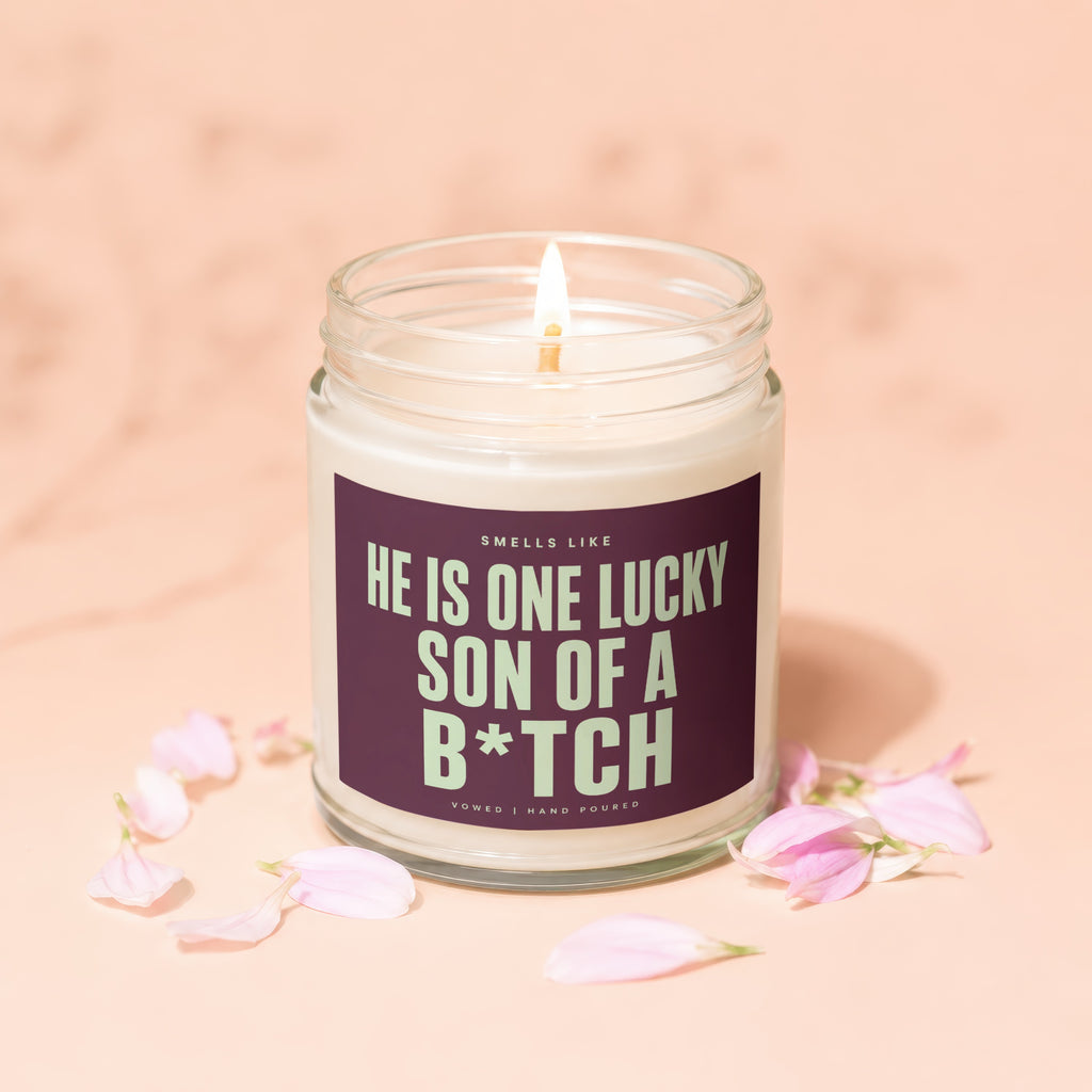 Lit candle with text "Smells like he is one lucky son of a b*tch".