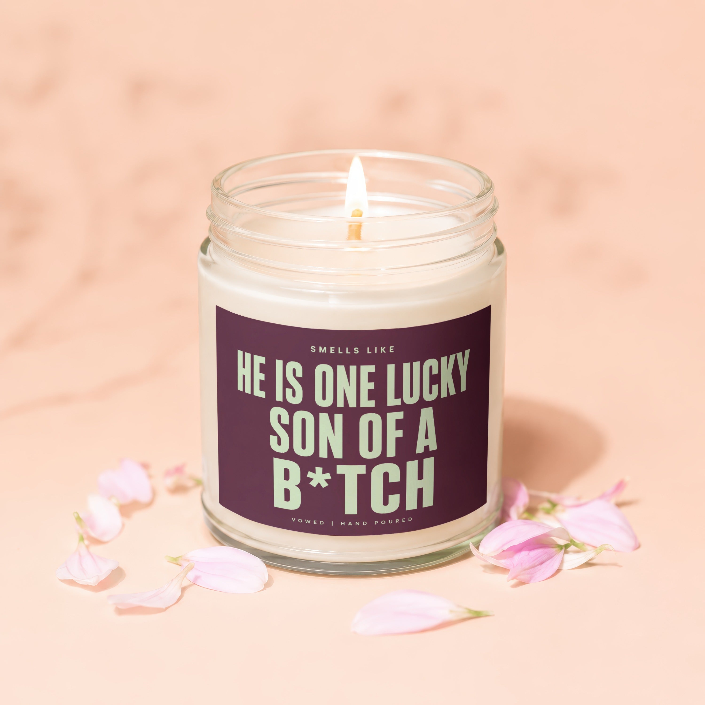 Lit candle with text "Smells like he is one lucky son of a b*tch".