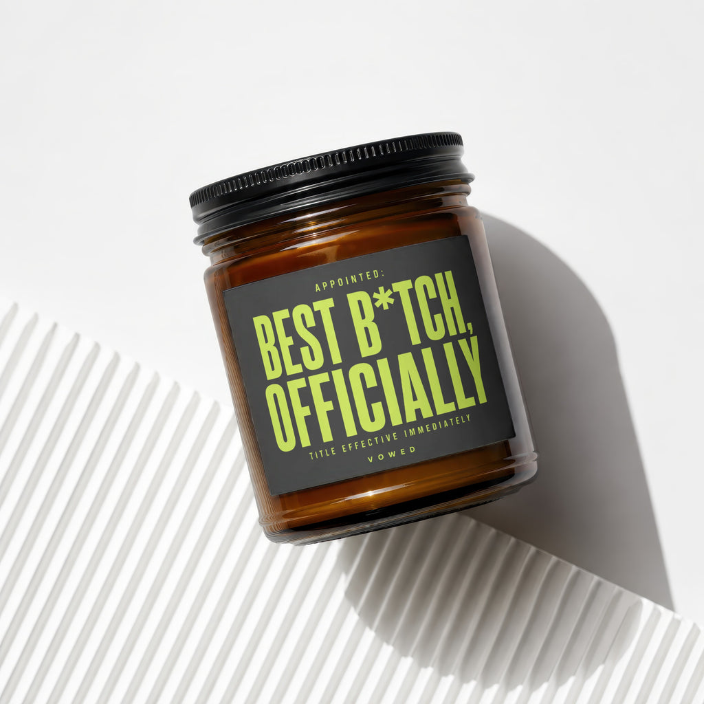 Amber jar candle with a black lid, featuring a dark gray label with lime green text.