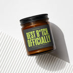 Amber jar candle with a black lid, featuring a dark gray label with lime green text.