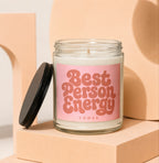 Glass candle with pink label saying "Best Person Energy VOWED".