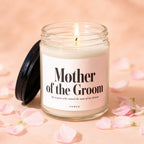 Mother of the Groom candle with lit flame and pink petals.