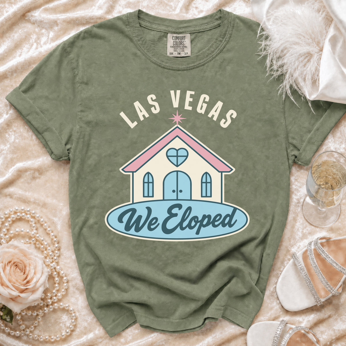 Green t-shirt with "LAS VEGAS We Eloped" text and a chapel graphic.