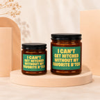 Two amber glass candles with black lids and green labels reading "I CAN'T GET HITCHED WITHOUT MY FAVORITE B*TCH".