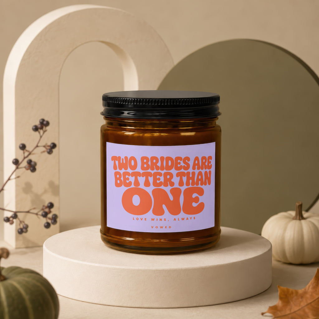 Amber jar candle on a pedestal with text "TWO BRIDES ARE BETTER THAN ONE".
