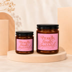 Two glass candles with pink labels reading "Proudly, finally, married."