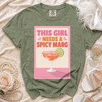 Olive t-shirt with "This Girl Needs A Spicy Marg" graphic and a margarita.
