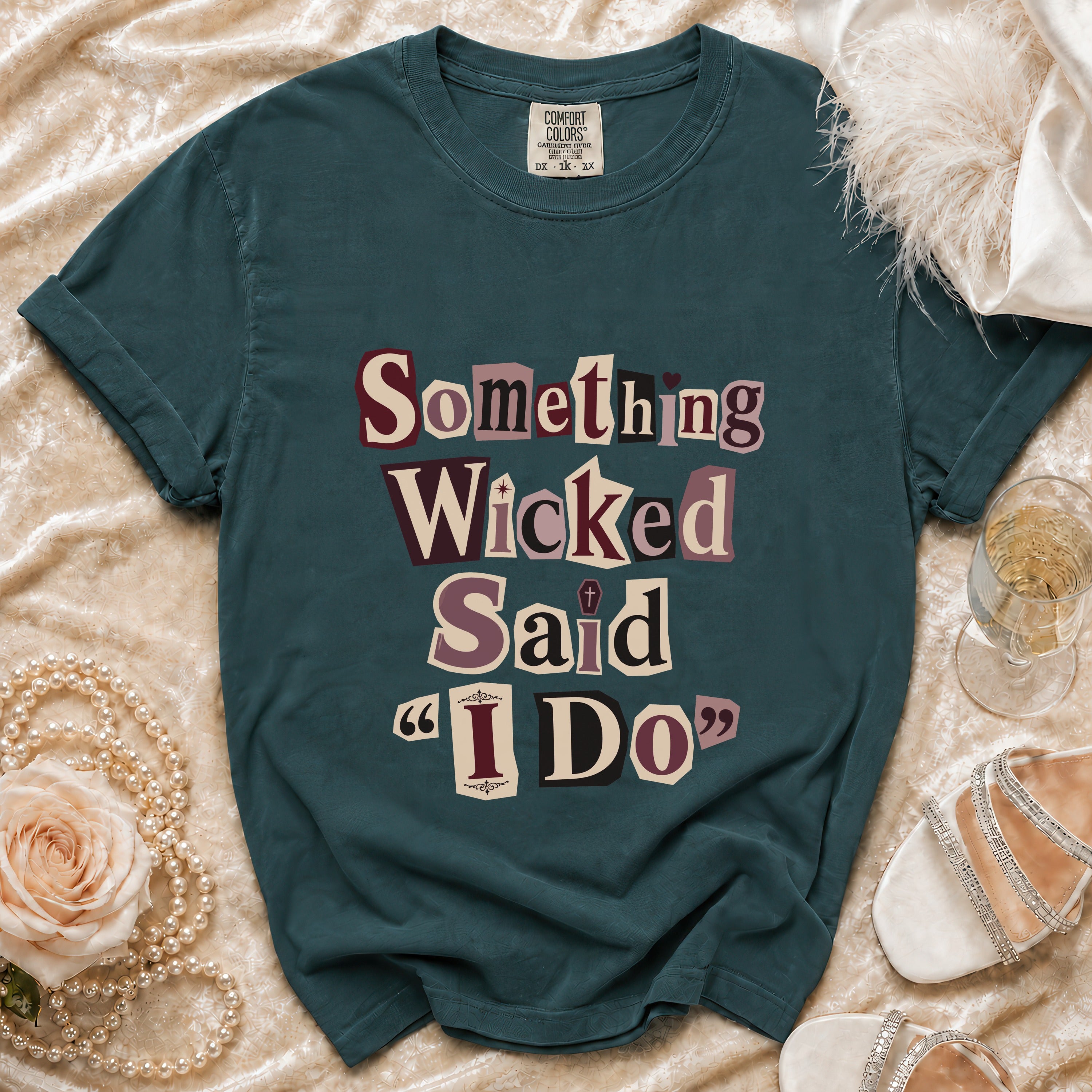 Teal t-shirt with "Something Wicked Said 'I Do'" text in cutout letters.