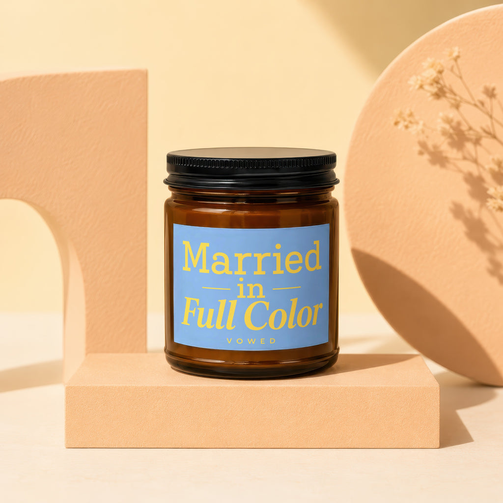 Amber jar candle with blue label saying "Married in Full Color VOWED".