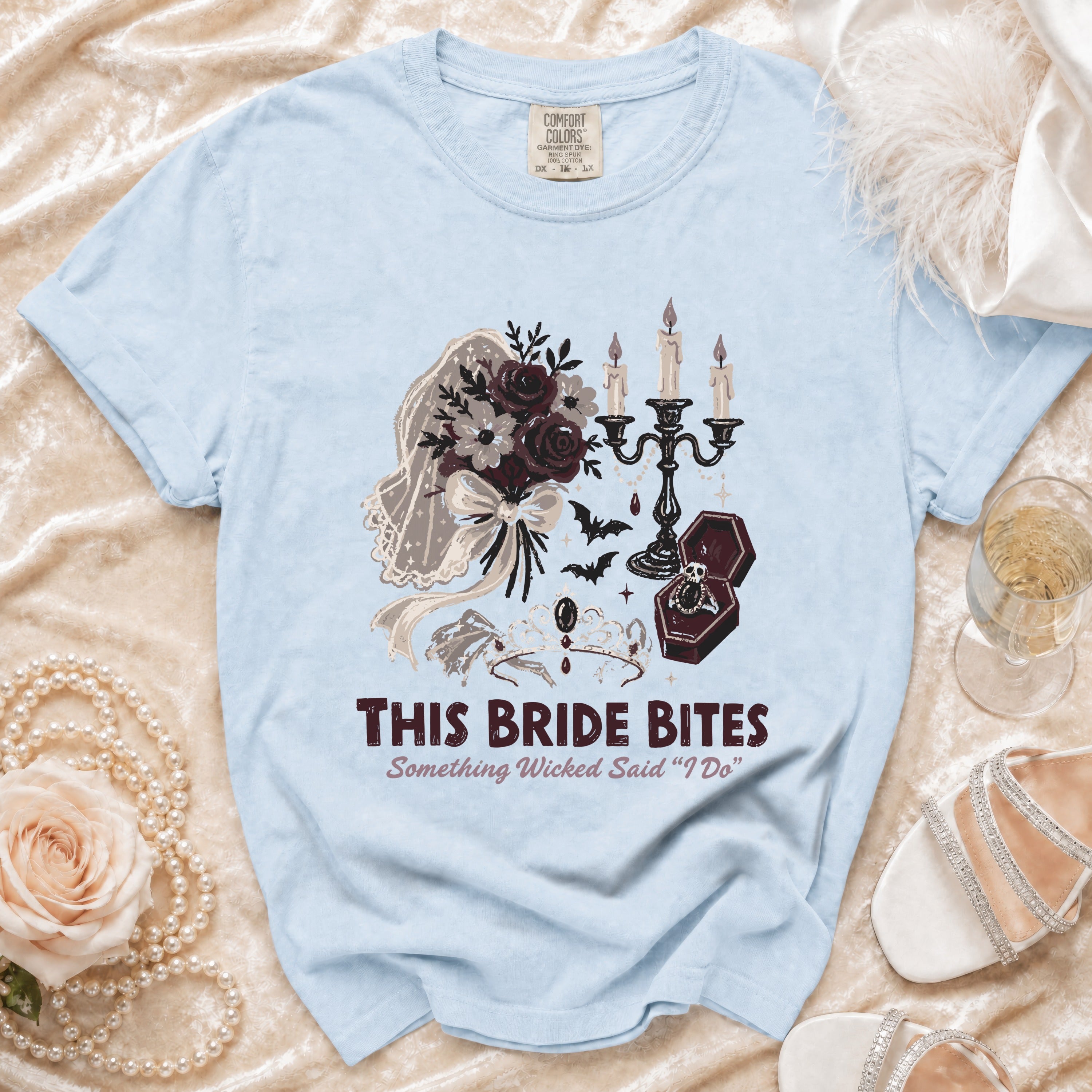 Light blue t-shirt with gothic wedding graphic and text: "THIS BRIDE BITES Something Wicked Said 'I Do'".