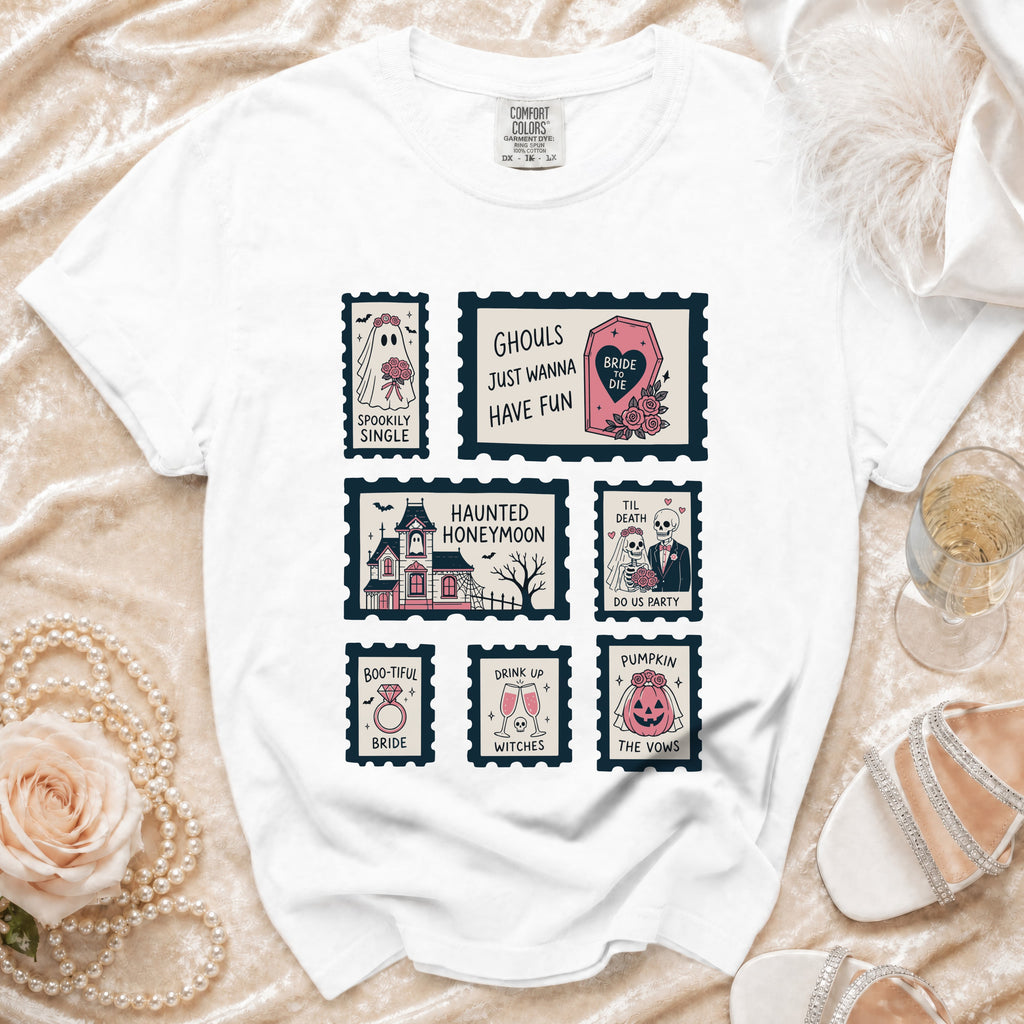 White t-shirt with postage stamp graphics featuring spooky bride, haunted house, and wedding-themed phrases.