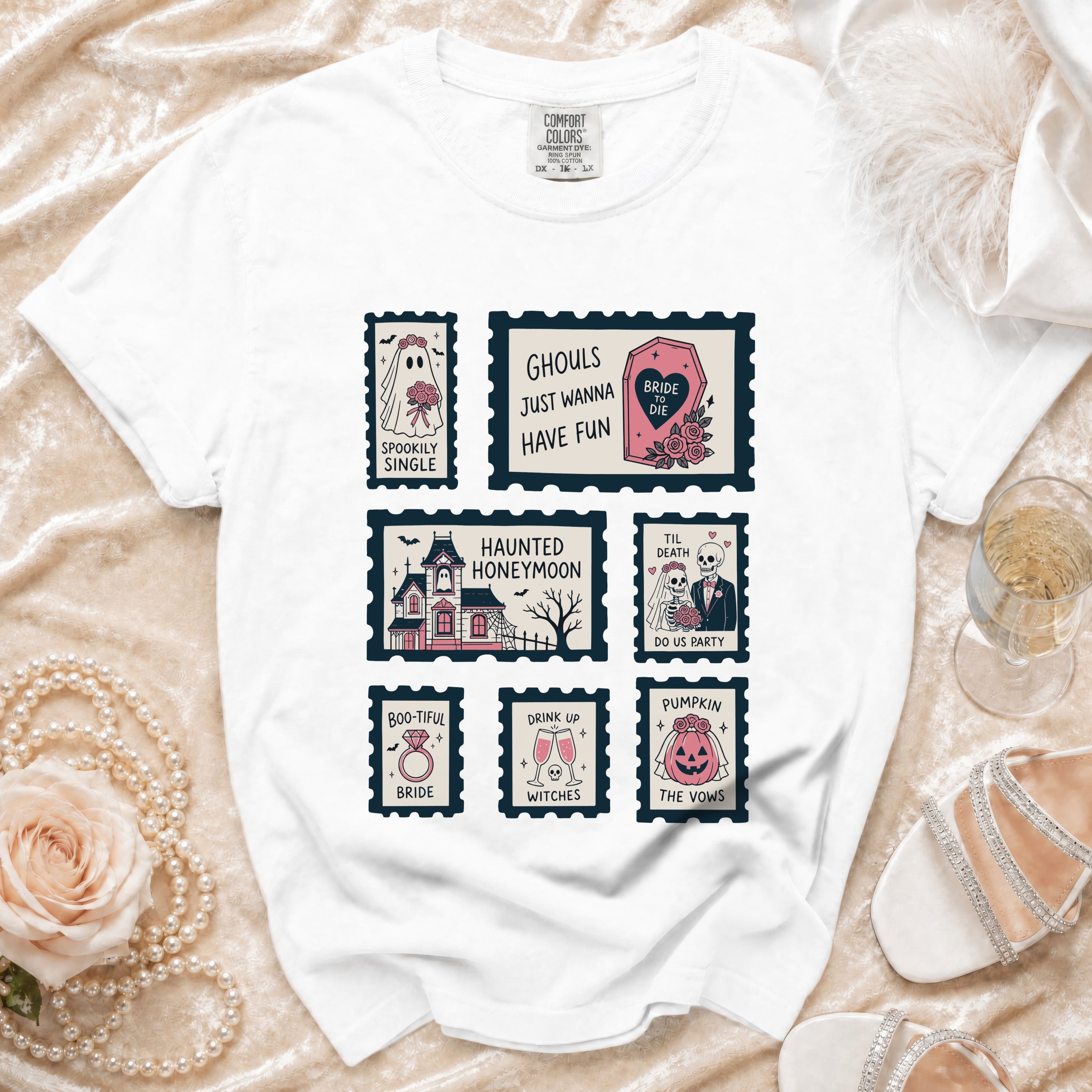 White t-shirt with postage stamp graphics featuring spooky bride, haunted house, and wedding-themed phrases.