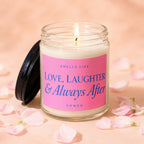 Lit candle in glass jar with pink label reading "Smells Like Love, Laughter & Always After"