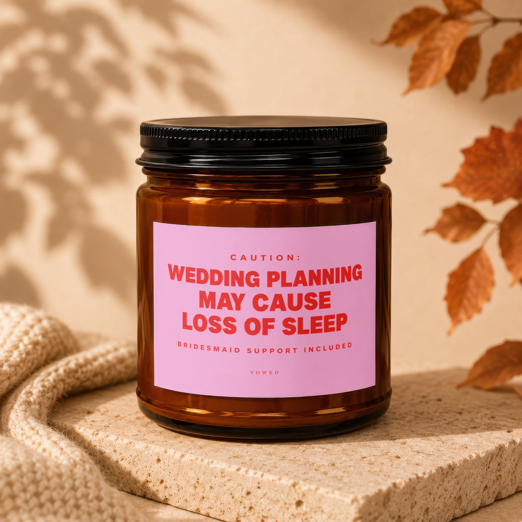 Amber jar candle with pink label reading "Wedding planning may cause loss of sleep".