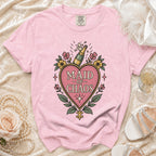 Pink t-shirt with "Maid of Chaos" graphic featuring a champagne bottle.