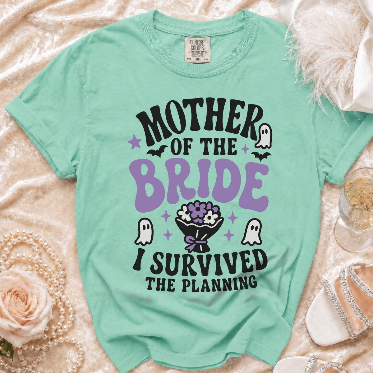 Mint green t-shirt with "Mother of the Bride I Survived the Planning" text and ghost graphics.