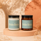 Two "Bride Brain" candles by Vowed in clear and amber jars.