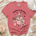 T-shirt with skeleton graphic that says "Mother of the Bride" and holds wine.