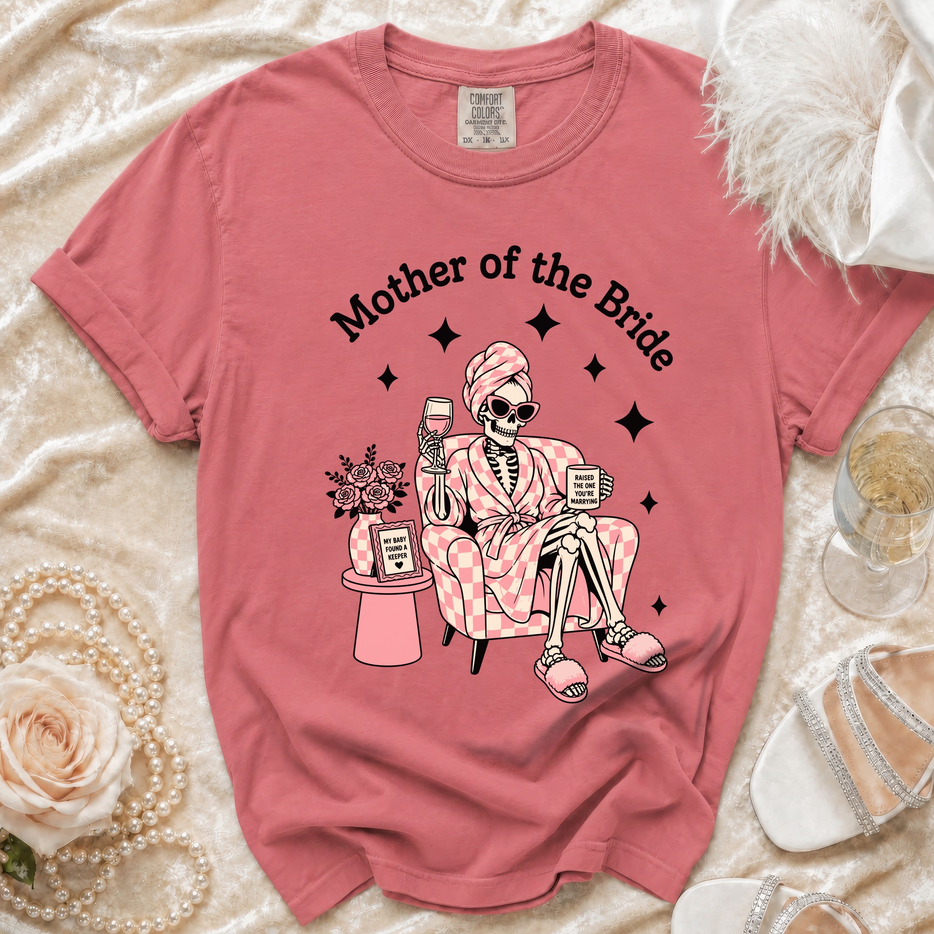 T-shirt with skeleton graphic that says "Mother of the Bride" and holds wine.