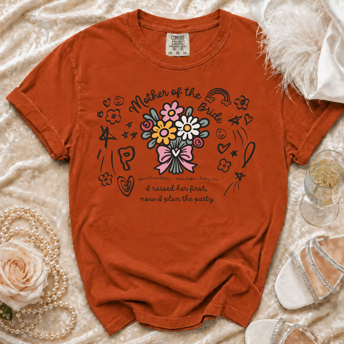 Orange t-shirt with "Mother of the Bride" floral graphic and sentimental text.