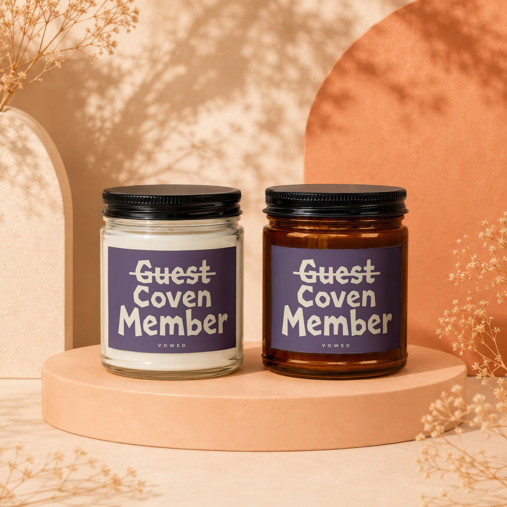 Two glass candles, one white and one amber, with "Guest Coven Member" text.