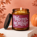 Amber candle with pink label that reads "Two Mrs, no mister" under "vowed."