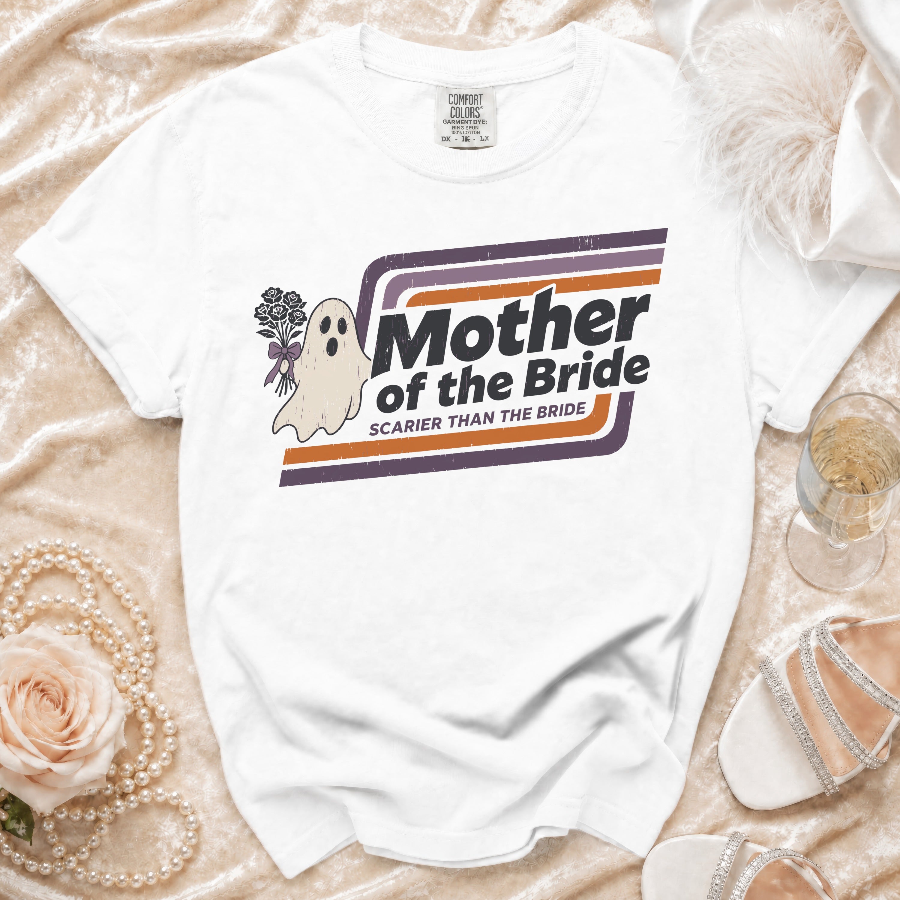 White t-shirt with a ghost holding flowers and text "Mother of the Bride".
