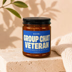 Candle with label "Rank: Group Chat Veteran Fourteen Months of Active Duty."