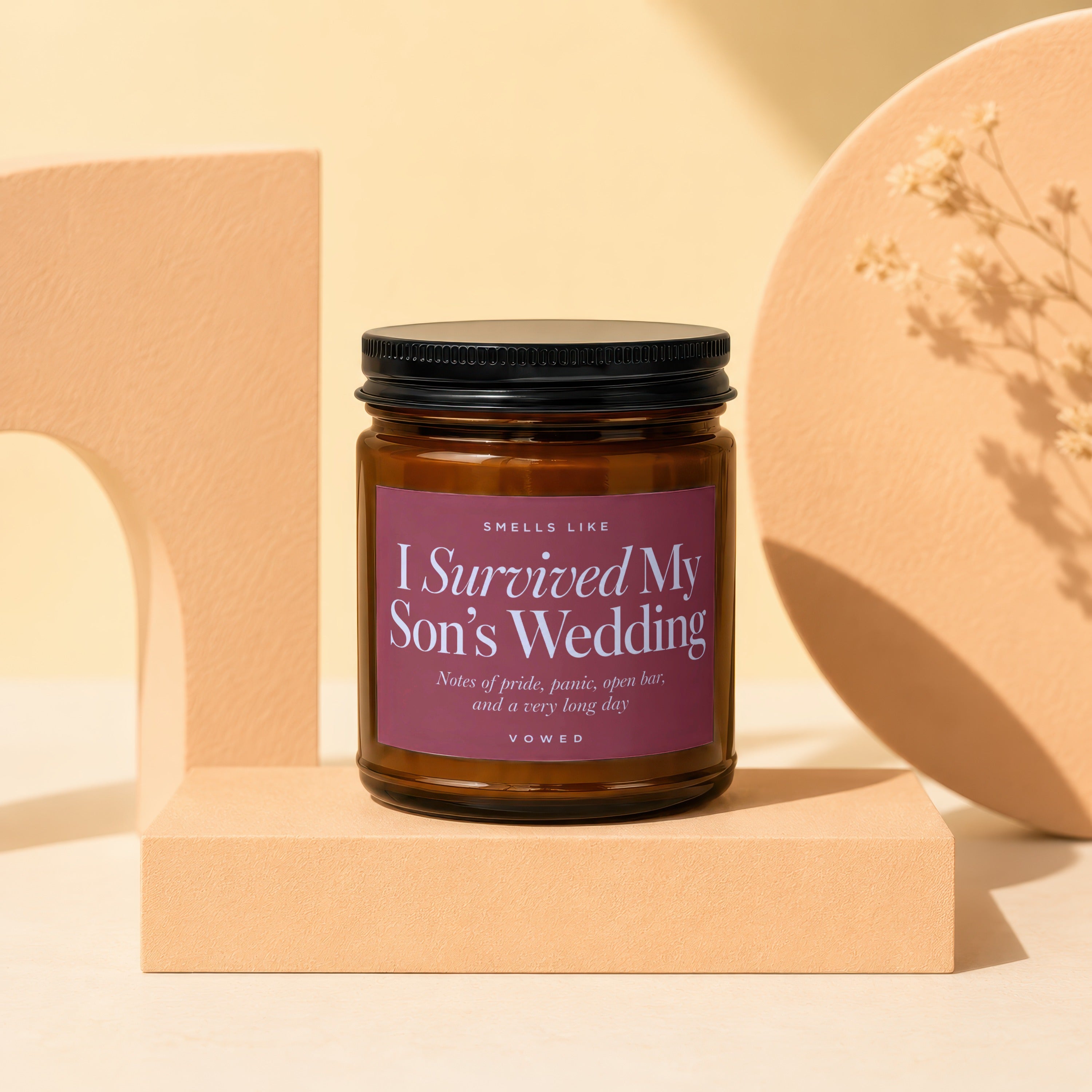 Brown candle with text "I Survived My Son's Wedding" and descriptive notes.