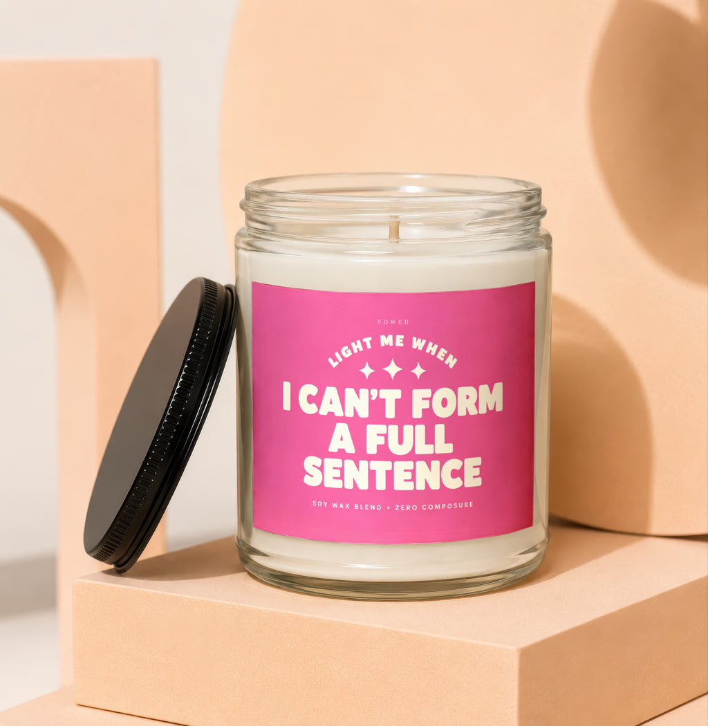 Candle with pink label reading "Light me when I can't form a full sentence."