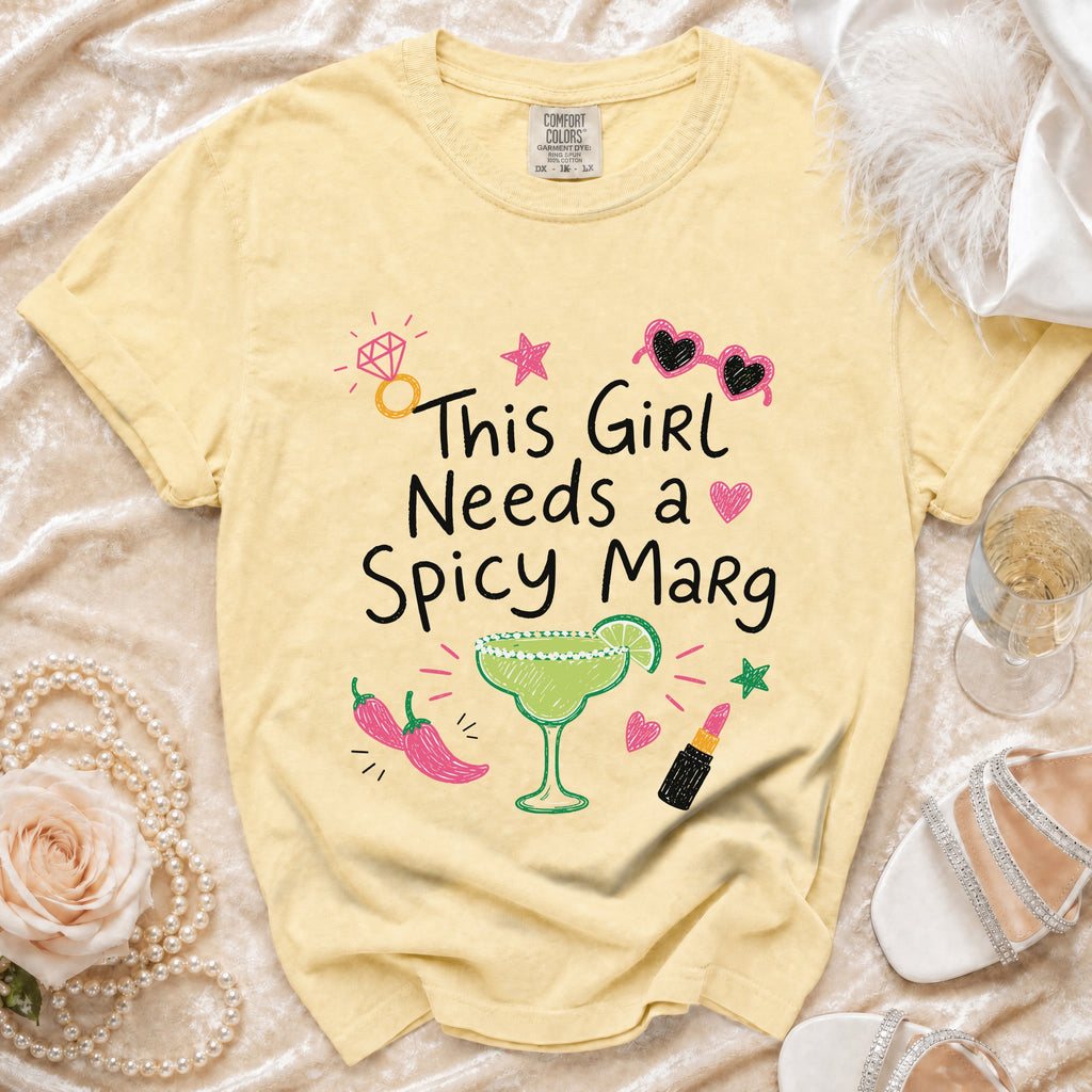 Yellow t-shirt with "This Girl Needs a Spicy Marg" and graphic elements.