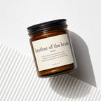 Amber glass candle with "brother of the bride" definition labeled.