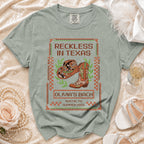 T-shirt with "Reckless in Texas" and cowboy boot graphic, for Olivia's Bach in Austin.