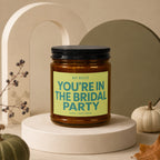 Amber jar candle with black lid, featuring text "HEY BESTIE YOU'RE IN THE BRIDAL PARTY."