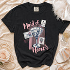 Black t-shirt with "Maid of Honor" text, martini glass, and stamps.