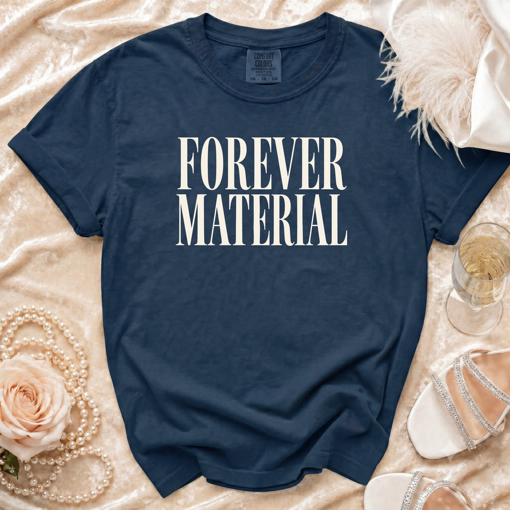 Navy t-shirt with "FOREVER MATERIAL" text, styled with pearls, rose, and shoes.