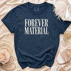 Navy t-shirt with "FOREVER MATERIAL" text, styled with pearls, rose, and shoes.