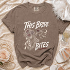 Brown t-shirt with "This Bride Bites" text, roses, ring, and bats graphic.