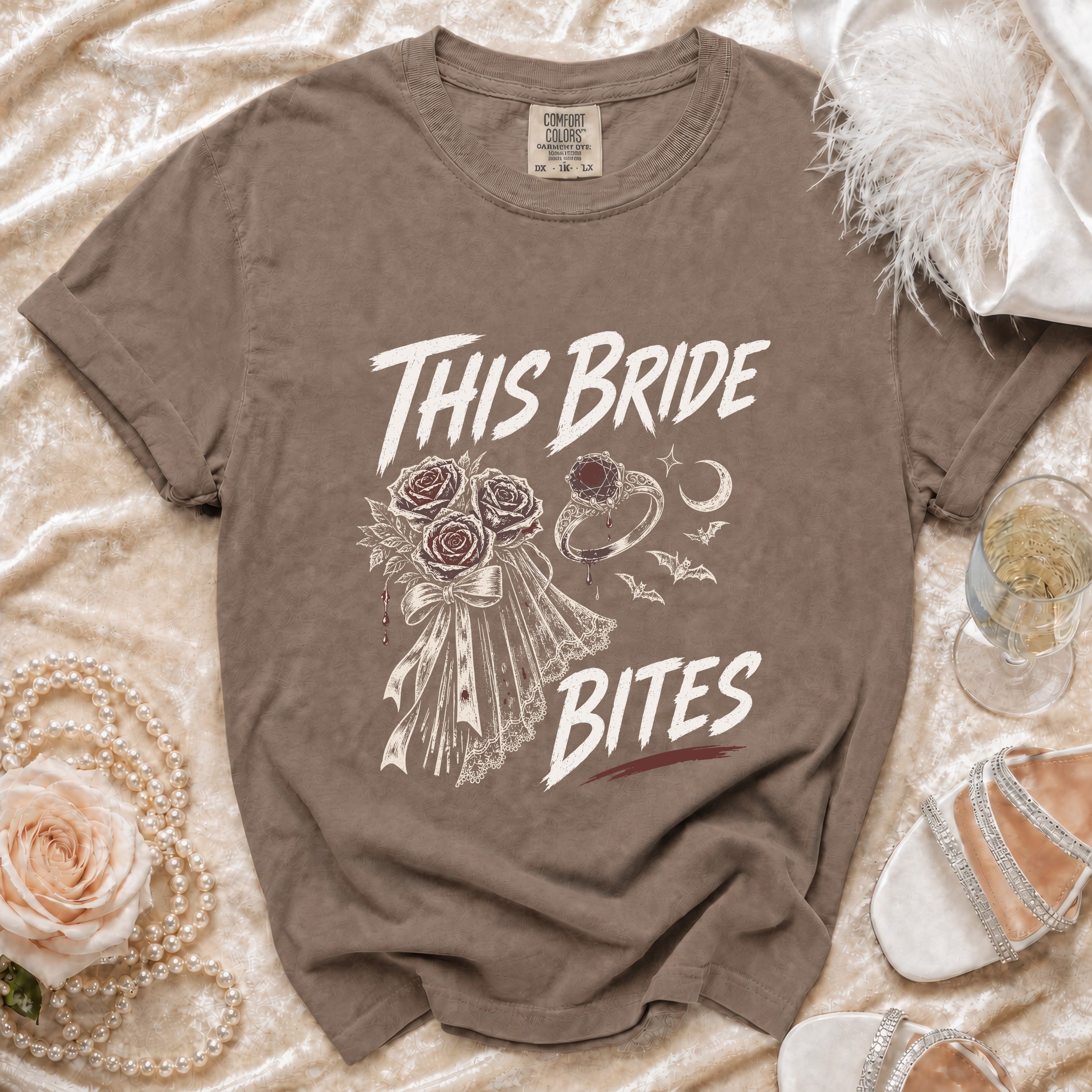 Brown t-shirt with "This Bride Bites" text, roses, ring, and bats graphic.
