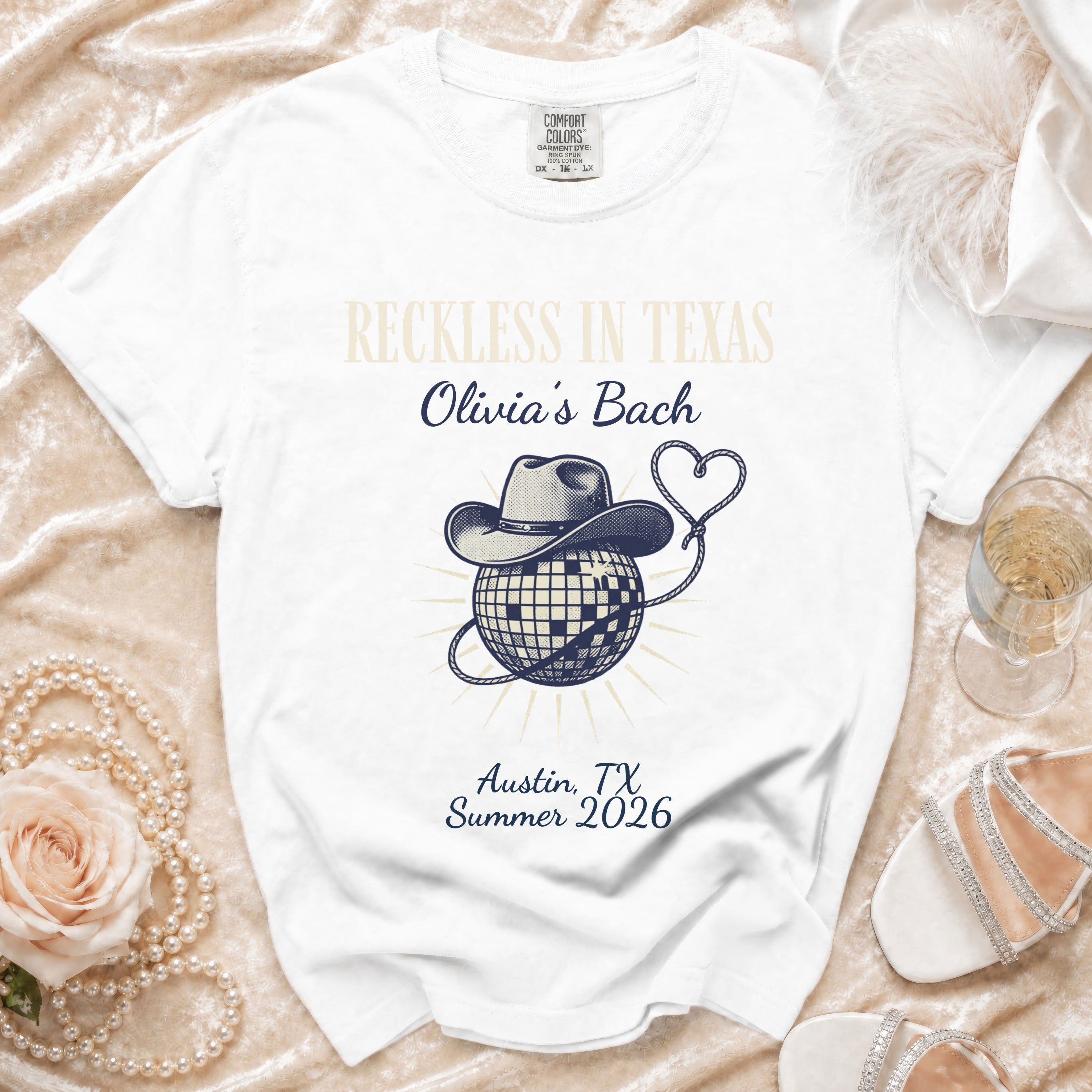 White t-shirt with "Reckless in Texas Olivia's Bach Austin, TX Summer 2026" design.