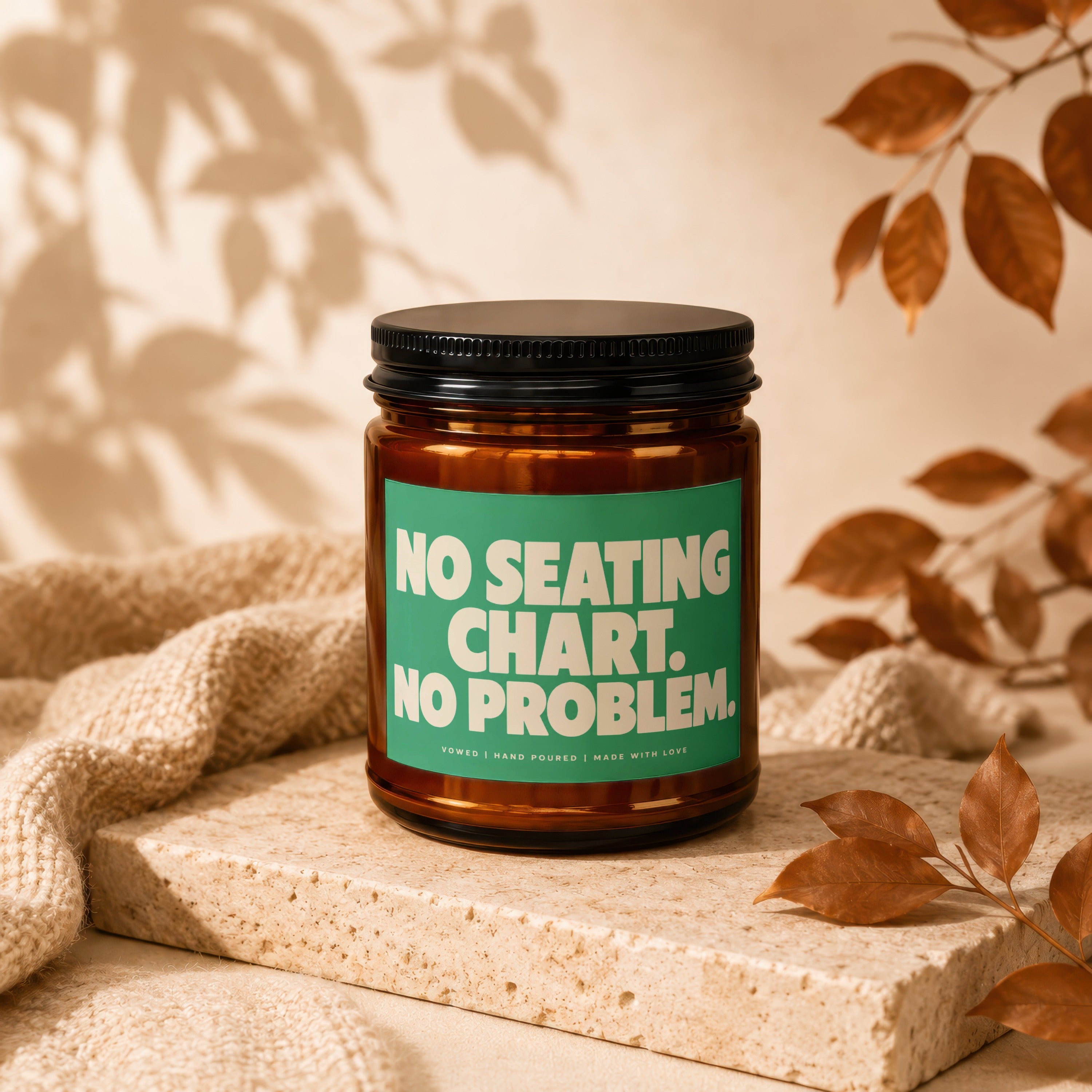 Amber jar candle with green label reading "NO SEATING CHART. NO PROBLEM."