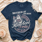 Navy blue t-shirt with "Mother of the Bride, Surviving Motherhood is Spooky But So Am I" graphic.