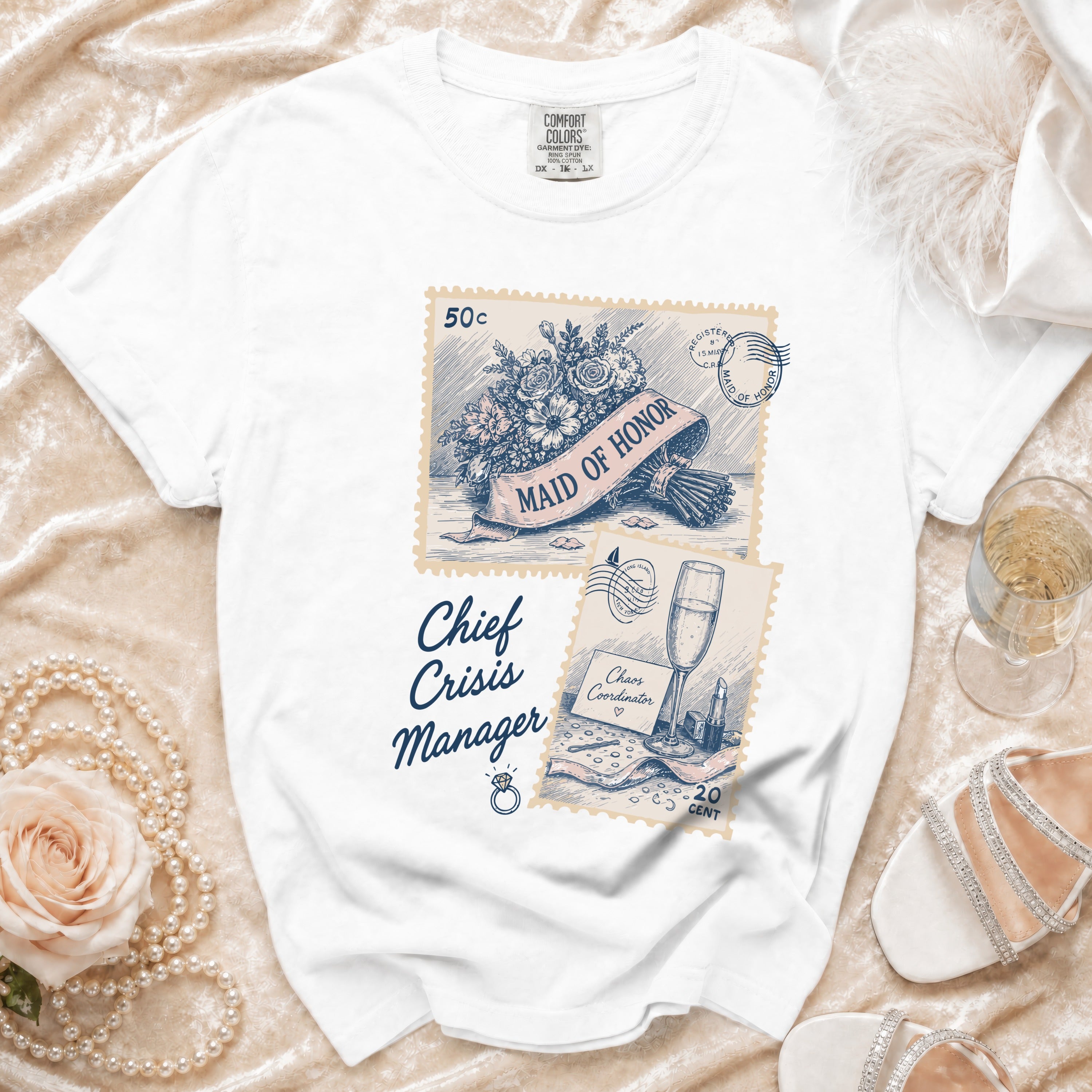 White t-shirt with "Maid of Honor" and "Chief Crisis Manager" text and postage stamp designs.