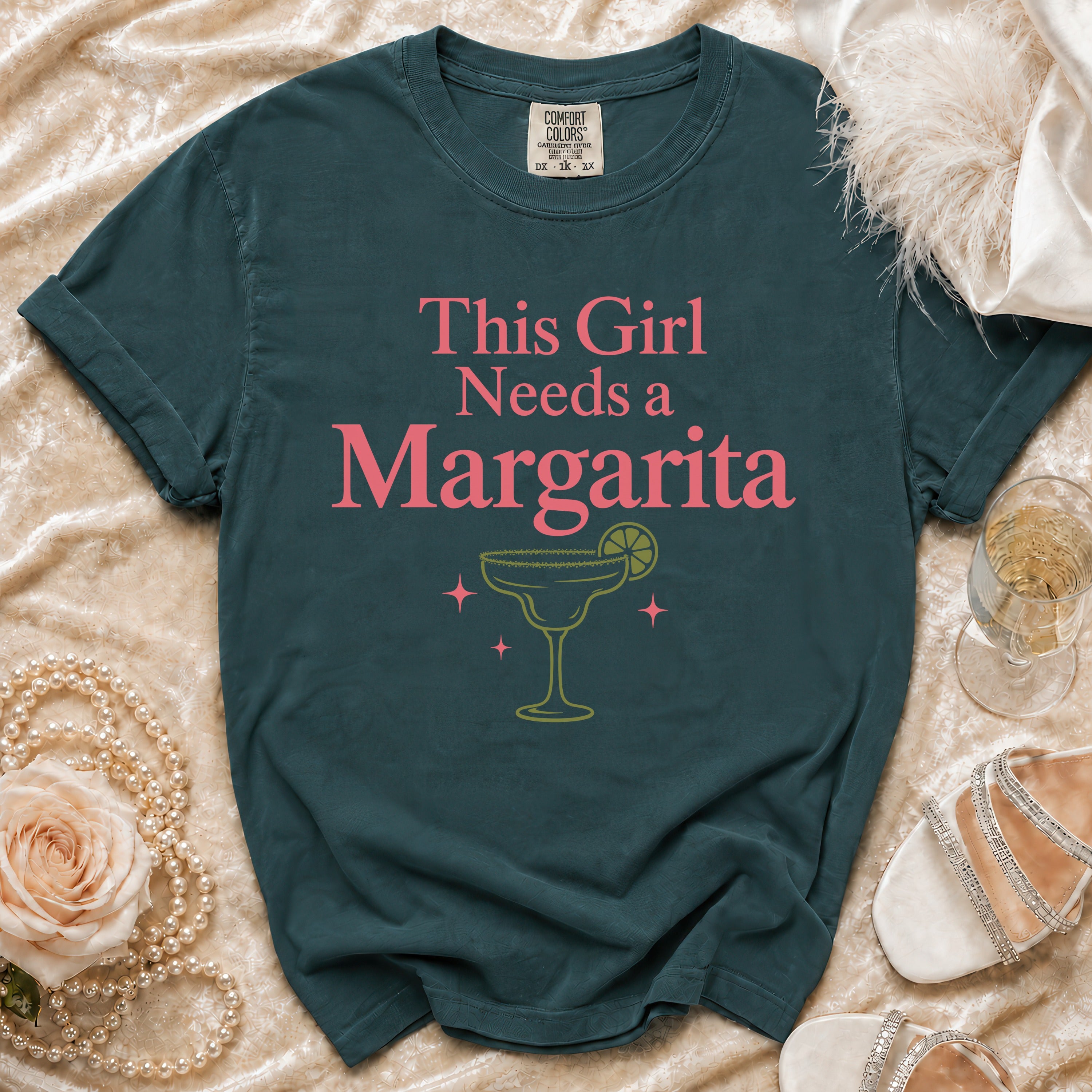 Teal Comfort Colors t-shirt with "This Girl Needs a Margarita" phrase and margarita graphic.