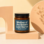 Amber jar candle with blue label reading "Mother of the Bride's Last Nerve Oh Look, It's on Fire!".