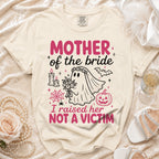 Cream t-shirt with "Mother of the bride, I raised her NOT A VICTIM" text.