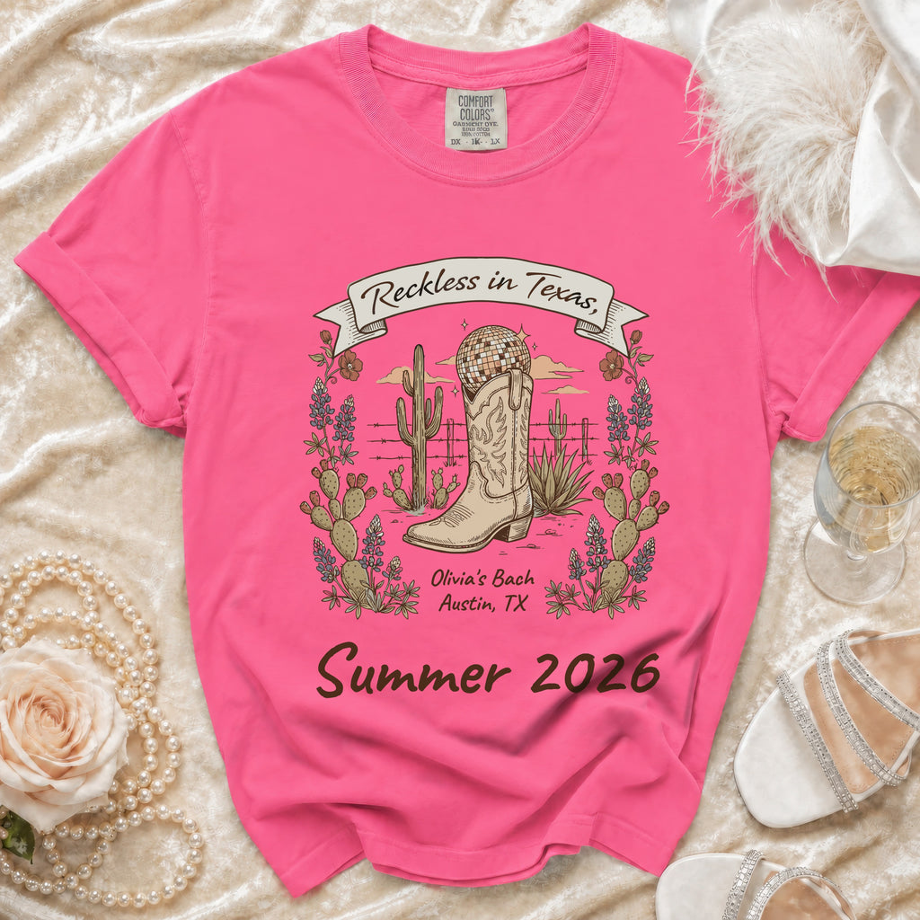 Pink t-shirt with "Reckless in Texas" and "Summer 2026" graphics.