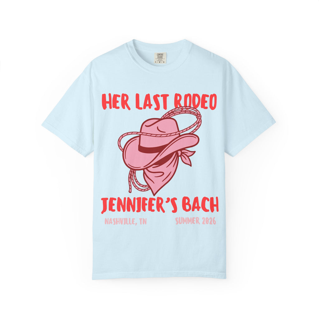 Light blue t-shirt with "Her Last Rodeo" text, cowboy hat, and rope.